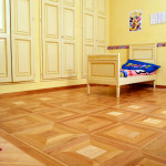 Wooden inlaid parquet-flooring, lacquered wall cupboard